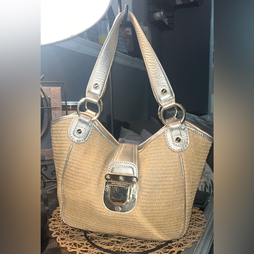 Michael Kors Deneuve straw tote with gold leather handles and hardware.